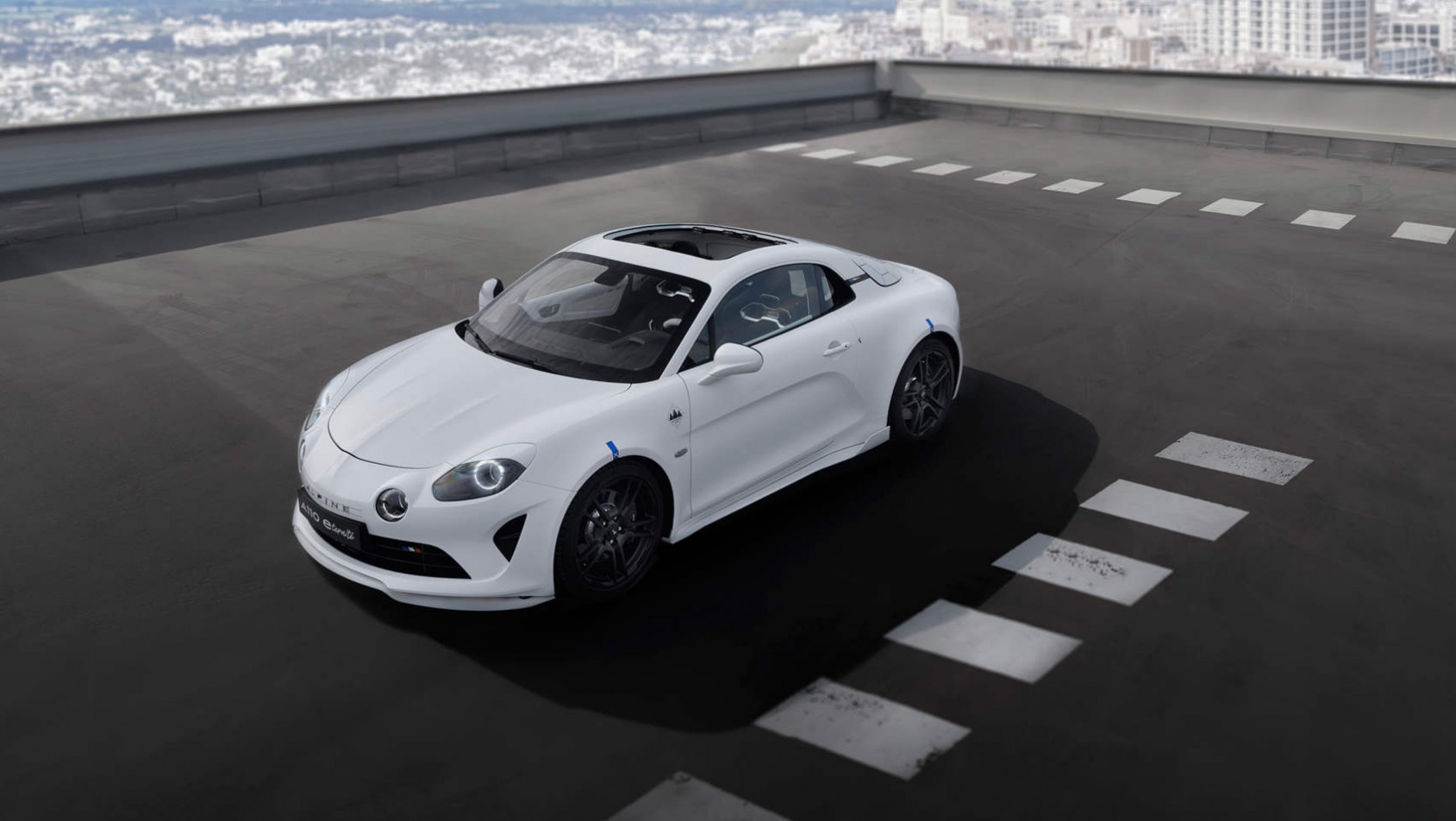 Biała Alpine A110 E-Ternité na zewnętrznym parkingu